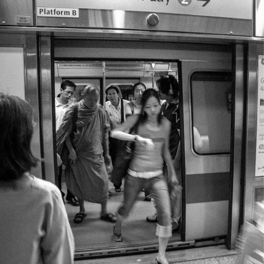 Commuters stepping off a train at Platform B, from REINKARNASI