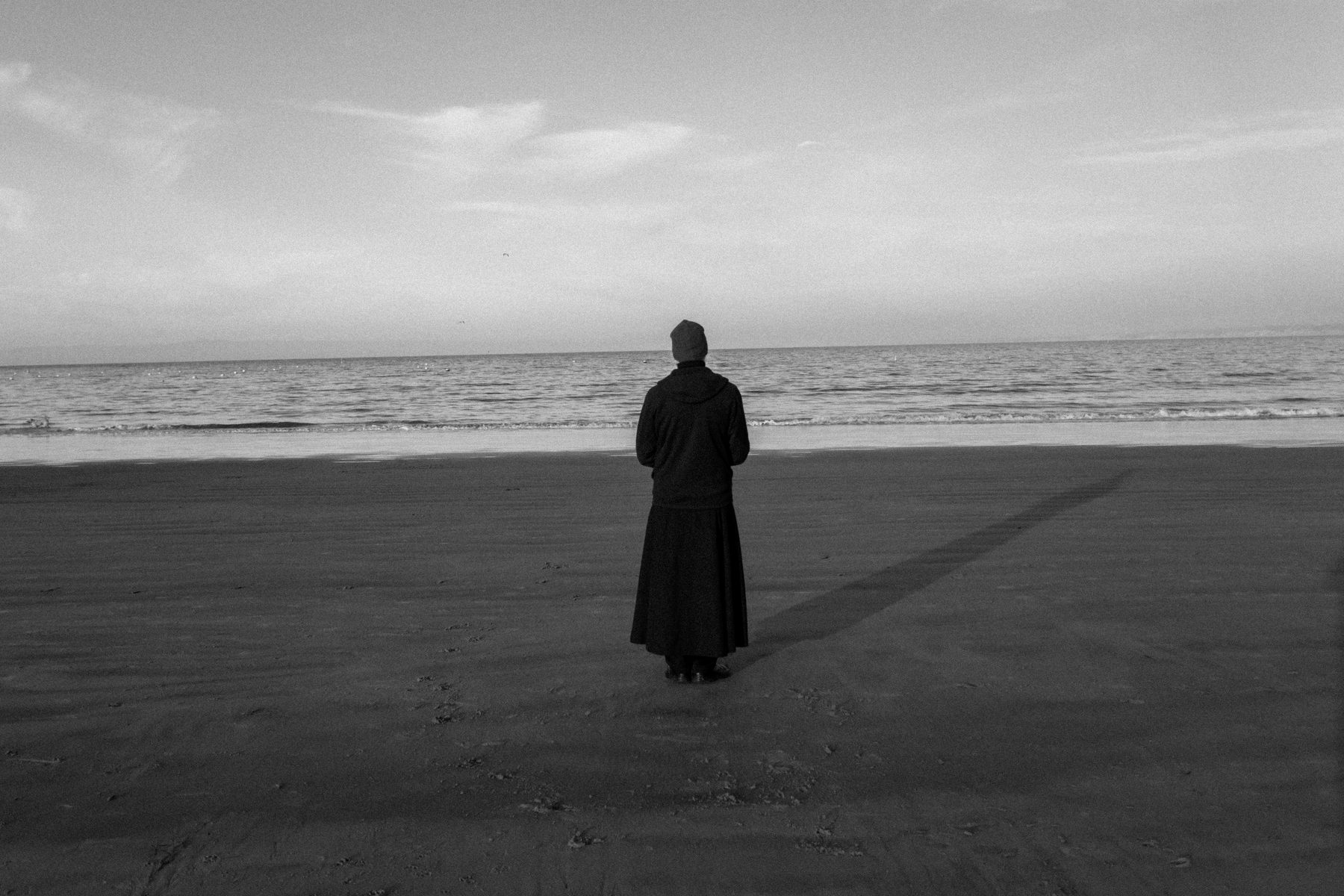 A man standing alone at the shore, from the series anātman