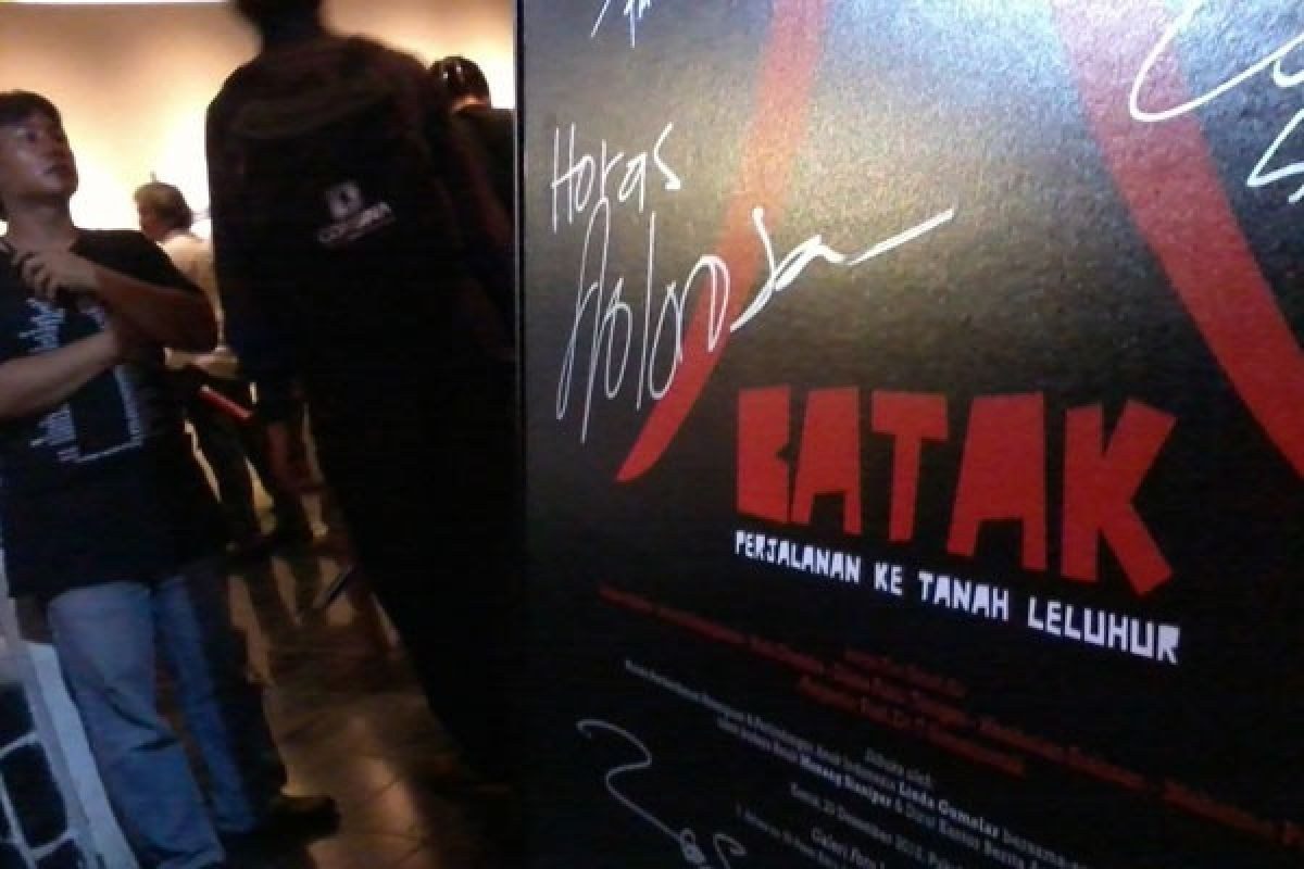 The signed film poster at the gallery entrance