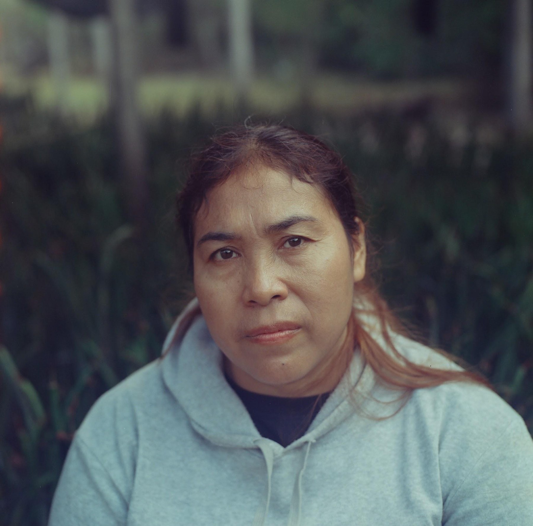 Close portrait of a woman in a grey hooded sweater